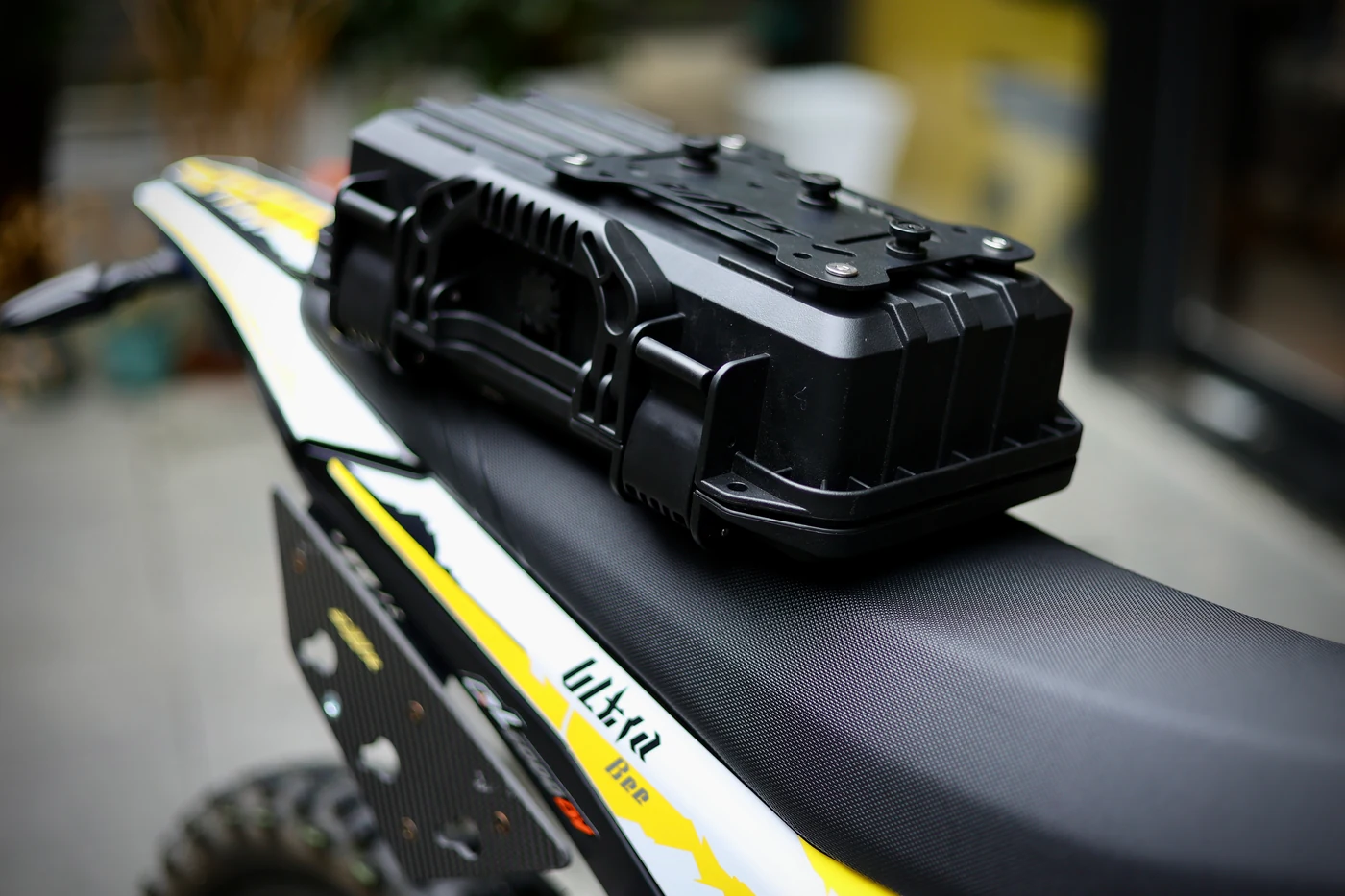 Detached side case resting above its Ultra Bee mounting bracket