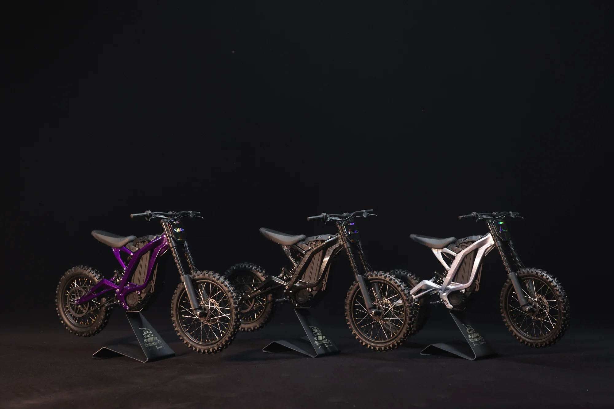 Purple, Black and Silver Light Bee models, from left to right