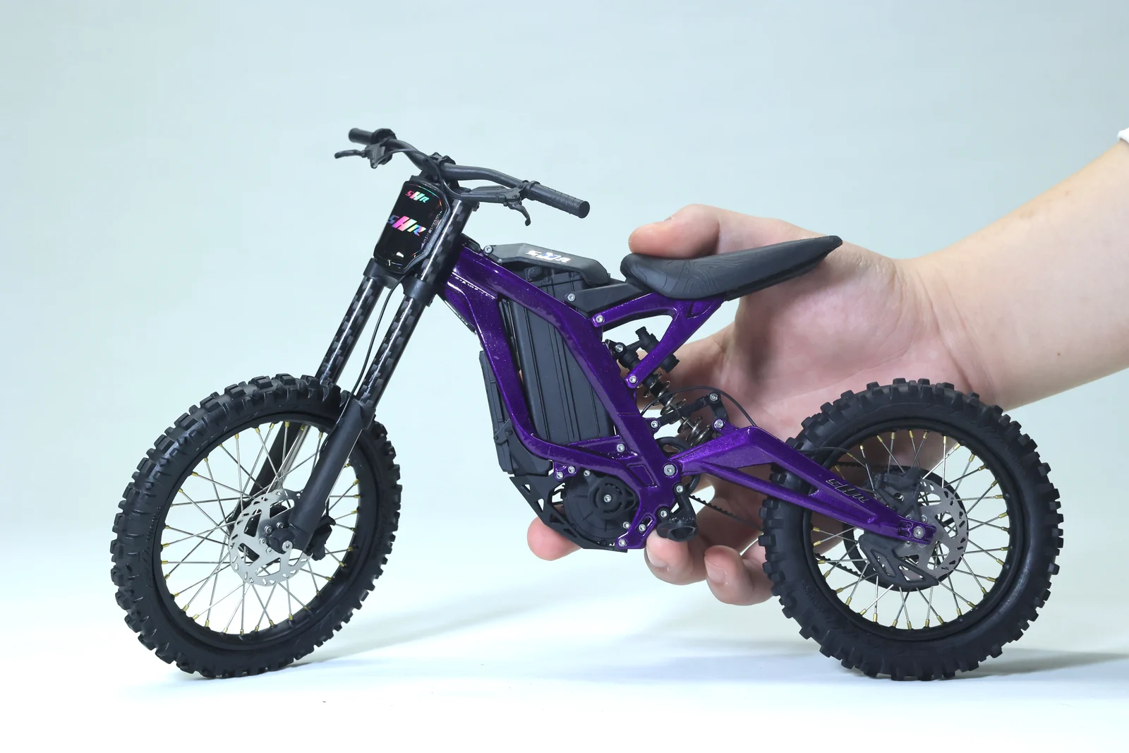 Purple Light Bee 1:6 model held in one hand to show its scale