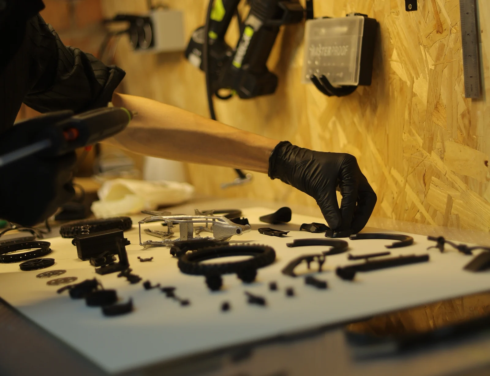 Hands assembling model components at the SHRworks workbench